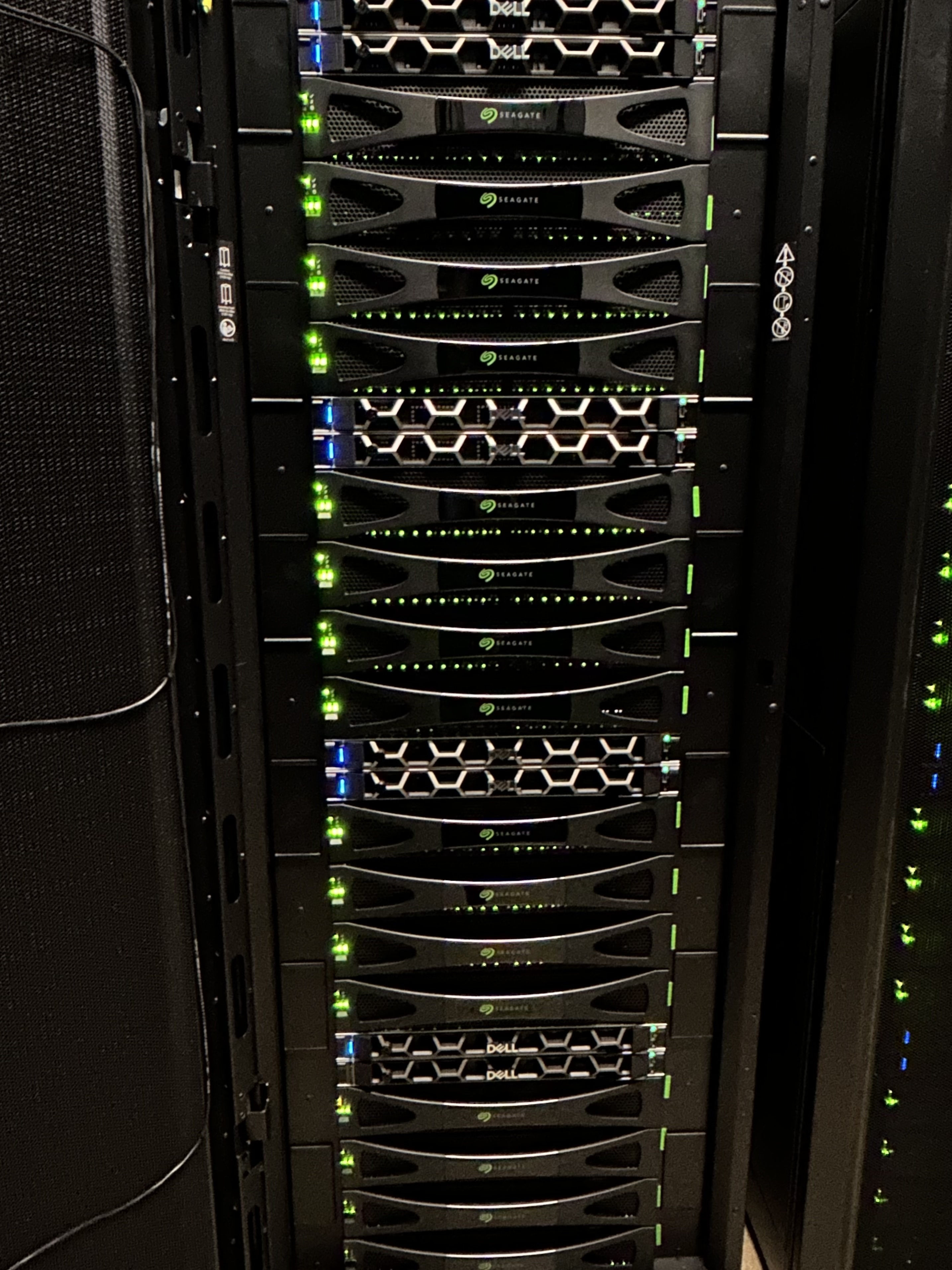 What 5 PB of flash storage look like A datacenter rack filled with Seagate enterprise SSD storage enclosures and Dell servers, with green activity LEDs glowing in a dark room.